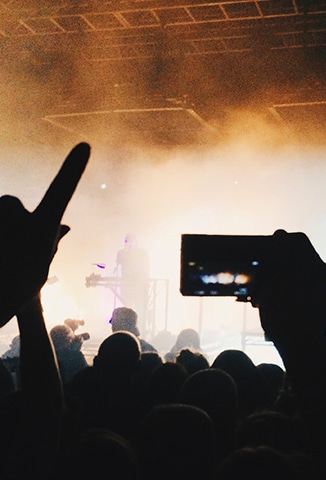 person filming a concert