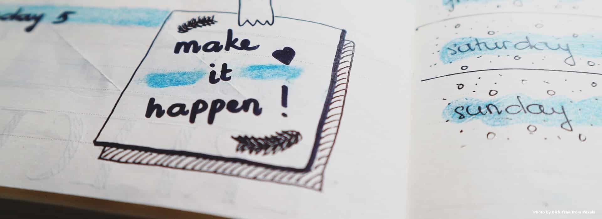notebook with doodles saying make it happen